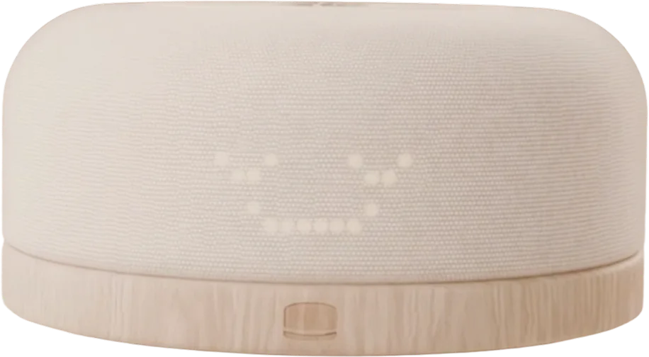 The Hushpup hub, a linen knit puck on a white oak base, smiling.